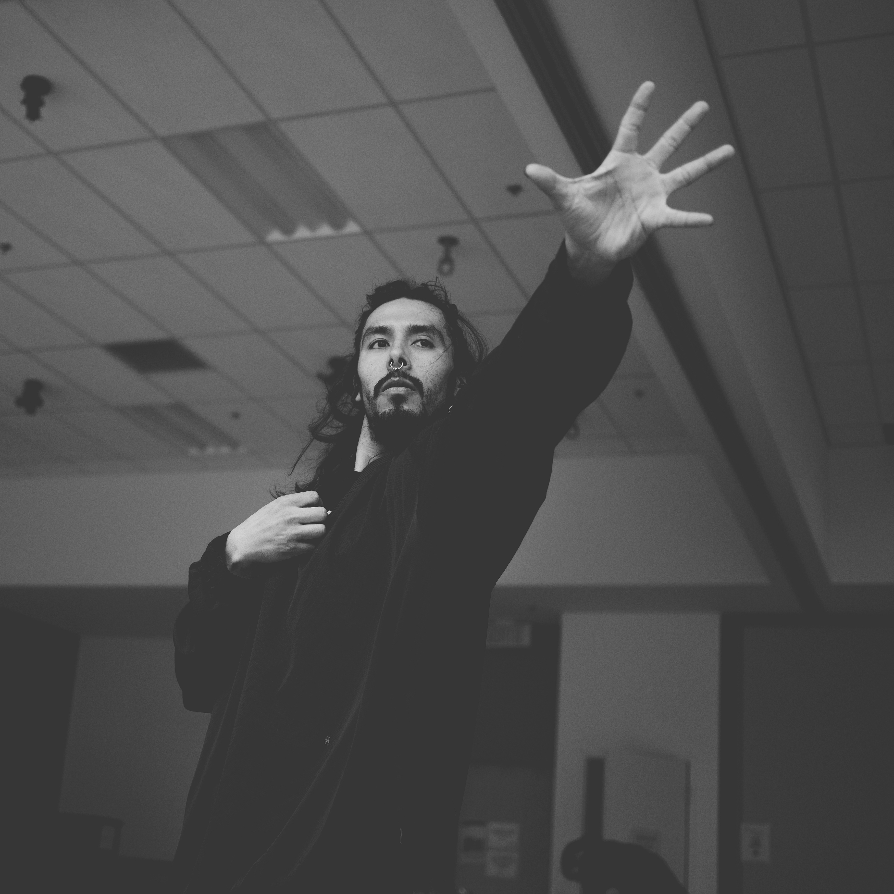 Nicolás, the artist behind Ferlucy, reaching upward with an open hand
