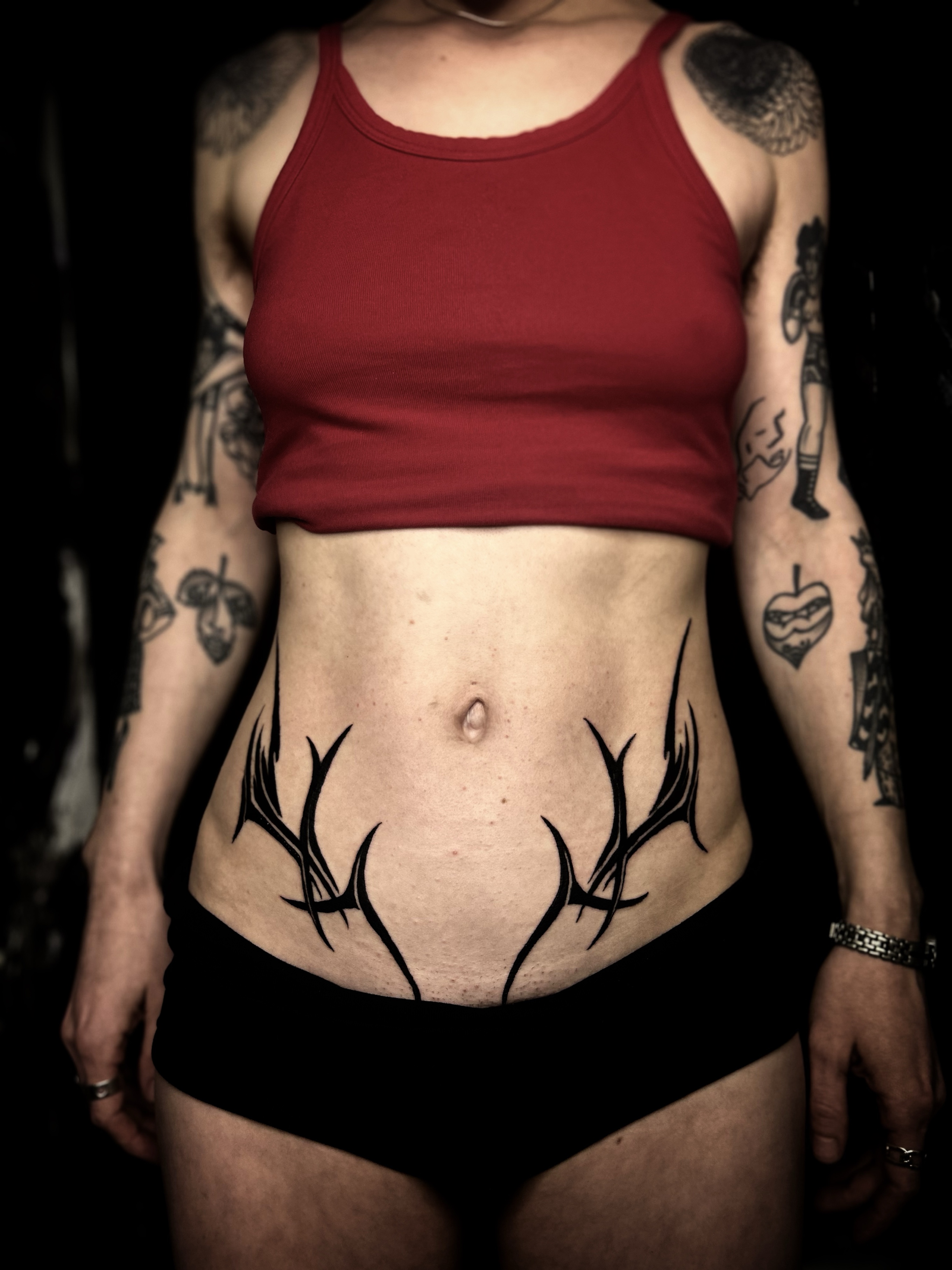 Antlers freehand piece across the lower abdomen