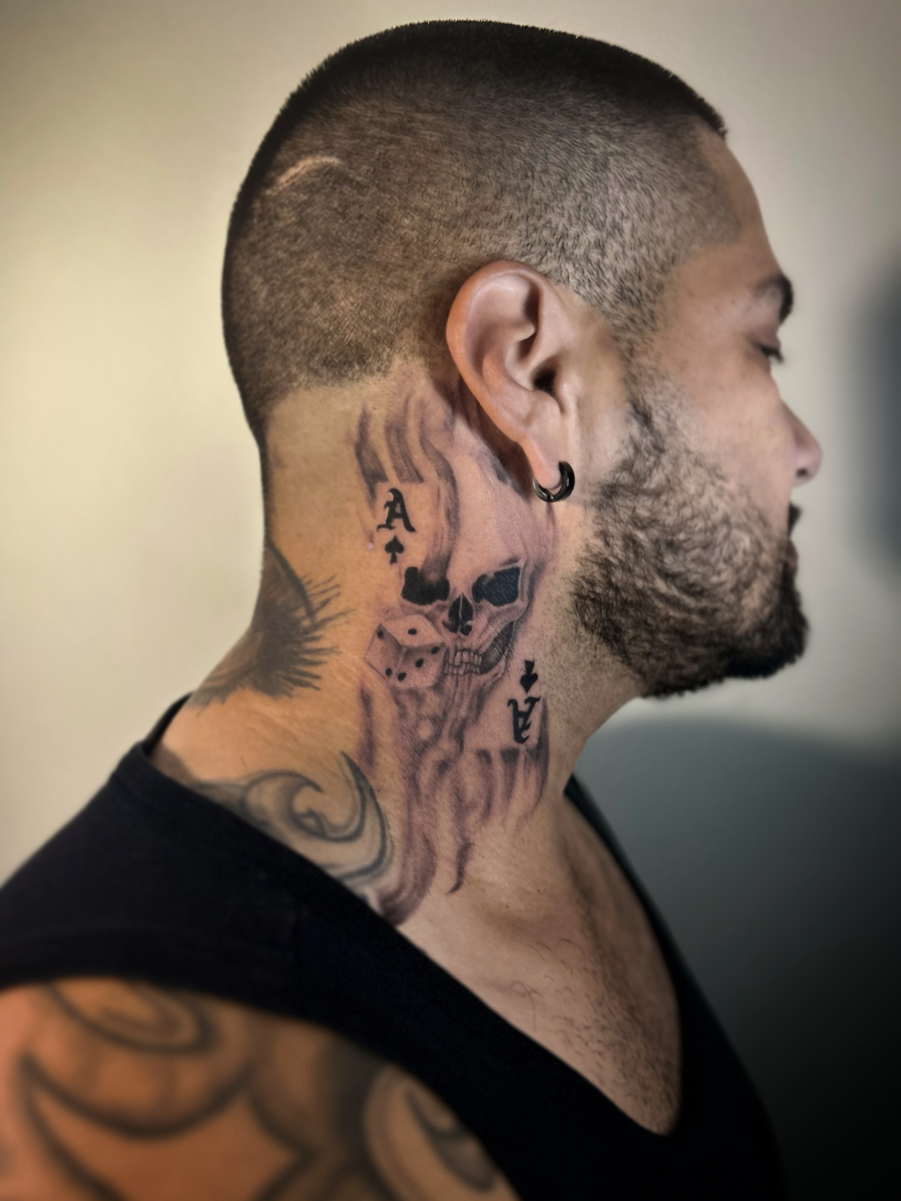 Playing card and skull composition across the neck