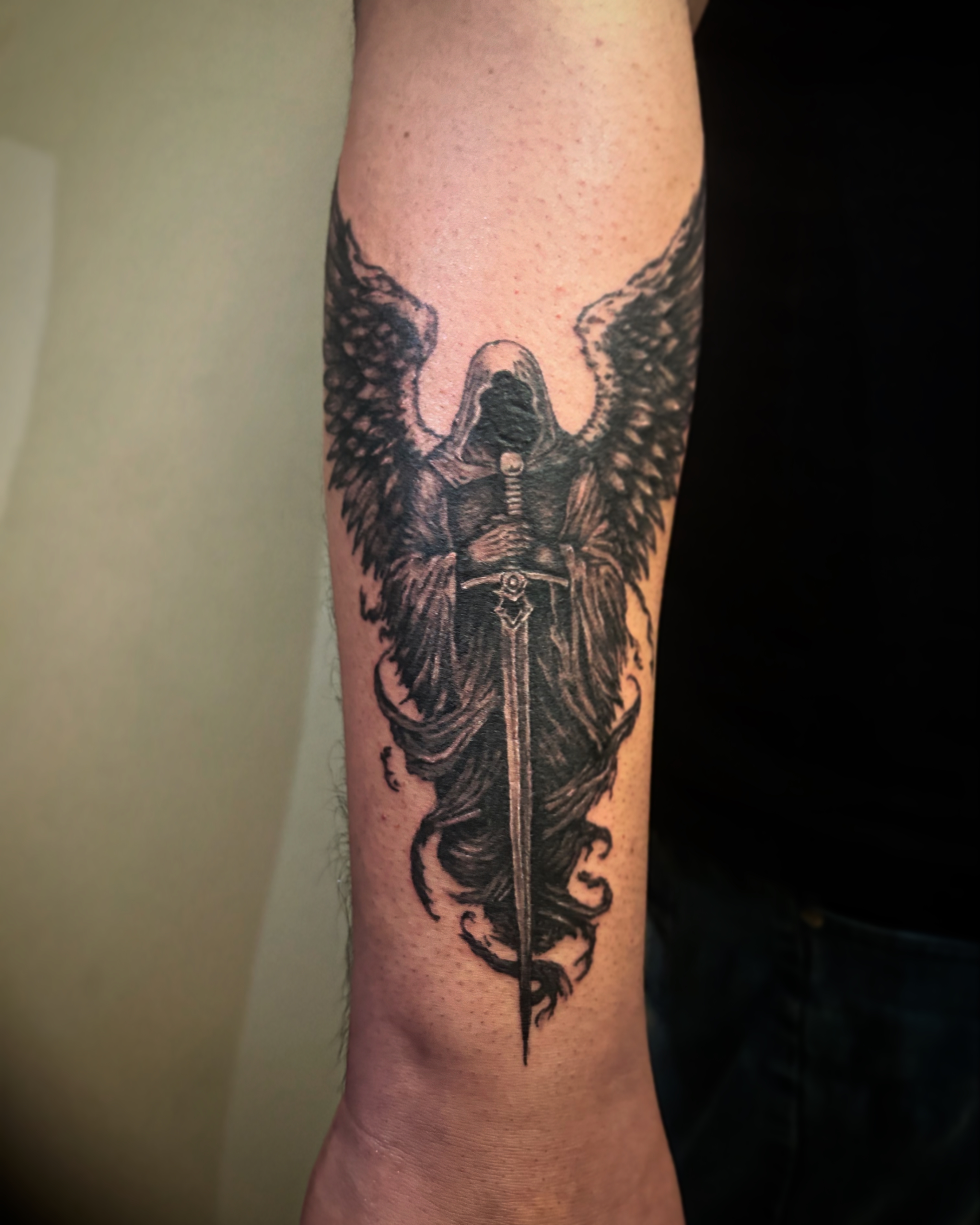 Hooded angel holding a sword